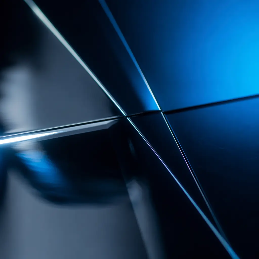 Clean geometric lines of reflected light on a polished dark surface, suggesting precision and measurement